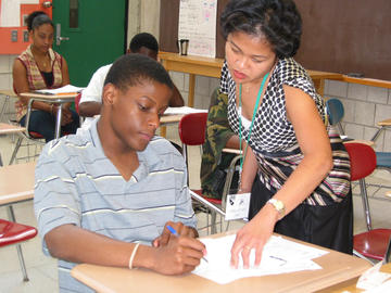 Teacher helping a student with his work